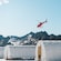 A helicopter flying over a sled dog camp on Denver Glacier, Alaska